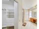 Bright bathroom and walk-in closet featuring a tub, shower, dual sinks and white shelving at 8540 Caitlin Ct, Hudson, FL 34667