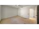 A bright bedroom with a ceiling fan, closet and entryway to the bathroom at 8540 Caitlin Ct, Hudson, FL 34667