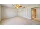 Bedroom showcasing plush carpeting, ceiling fan, and an ensuite bathroom at 8540 Caitlin Ct, Hudson, FL 34667