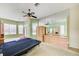 Spacious bedroom features carpet floors, a ceiling fan, and built in storage at 8540 Caitlin Ct, Hudson, FL 34667