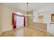 Inviting dining room with wood floors, chandelier, and bright window at 8540 Caitlin Ct, Hudson, FL 34667
