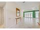 Entryway with console table and mirror leading to living area with view to the pool and lanai at 8540 Caitlin Ct, Hudson, FL 34667