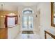Bright foyer with double doors, arched window, tile floor and neutral walls at 8540 Caitlin Ct, Hudson, FL 34667