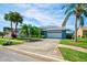 Charming single-story home with a lush green lawn and mature tropical landscaping, creating a welcoming curb appeal at 8540 Caitlin Ct, Hudson, FL 34667
