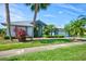 Charming single-story home with a lush green lawn and mature tropical landscaping, creating a welcoming curb appeal at 8540 Caitlin Ct, Hudson, FL 34667