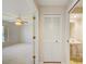 Hallway view leading to bedroom with ceiling fan, plus bathroom with pedestal sink and wallpaper at 8540 Caitlin Ct, Hudson, FL 34667