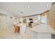 Well-lit kitchen with a central island, bar stools, and modern stainless steel appliances at 8540 Caitlin Ct, Hudson, FL 34667