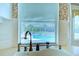 Kitchen sink and faucet view showcases the pool outside the kitchen window at 8540 Caitlin Ct, Hudson, FL 34667