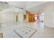 Open-concept living area with tile flooring, large mirror, and views of the entryway and dining space at 8540 Caitlin Ct, Hudson, FL 34667
