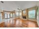 Spacious living room with fireplace, wood floors and a ceiling fan at 8540 Caitlin Ct, Hudson, FL 34667