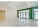 Bright living room boasts tile flooring and pool views via expansive french doors at 8540 Caitlin Ct, Hudson, FL 34667