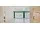 Bright living room with tile floors, large windows, and an open layout at 8540 Caitlin Ct, Hudson, FL 34667
