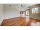 An open-concept living room featuring wood floors, a large window, and access to kitchen at 8540 Caitlin Ct, Hudson, FL 34667