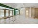 Large living room with tile floors and a view of the pool through french doors at 8540 Caitlin Ct, Hudson, FL 34667