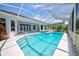 Inviting pool area featuring a screened enclosure with access to the home's interior at 8540 Caitlin Ct, Hudson, FL 34667