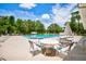 Community pool area with plenty of seating, umbrellas, and mature trees providing shade at 8540 Caitlin Ct, Hudson, FL 34667