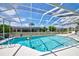 Sparkling pool with a beach ball and a screened enclosure for outdoor enjoyment at 8540 Caitlin Ct, Hudson, FL 34667