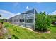 Screened-in pool area, providing a private and enjoyable outdoor experience with lush greenery at 8540 Caitlin Ct, Hudson, FL 34667