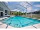 Relaxing in-ground pool with a screened-in enclosure, perfect for enjoying the outdoors at 8540 Caitlin Ct, Hudson, FL 34667