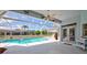 A covered patio overlooking the screened pool area, complete with a beach ball at 8540 Caitlin Ct, Hudson, FL 34667