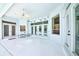 A covered patio with ceiling fan, tile flooring, and access to the screened-in pool at 8540 Caitlin Ct, Hudson, FL 34667
