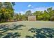 Outdoor racquetball court in a community recreation area with mature trees and landscaping at 8540 Caitlin Ct, Hudson, FL 34667