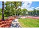 Community tennis courts with manicured lawns and mature trees; perfect for tennis enthusiasts at 8540 Caitlin Ct, Hudson, FL 34667