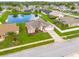 Aerial shot showcasing the house, street, and a pond behind the house at 8811 Napa Loop, New Port Richey, FL 34653