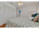 Bright bedroom with closet and ceiling fan, decorated with soothing colors and comfortable bedding at 8811 Napa Loop, New Port Richey, FL 34653