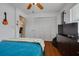 Bright bedroom featuring a closet, with a TV and dresser setup at 8811 Napa Loop, New Port Richey, FL 34653