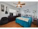 Bedroom with ample natural light, ceiling fan, and entertainment setup, perfect for relaxation at 8811 Napa Loop, New Port Richey, FL 34653
