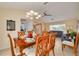 Dining room with a beautiful chandelier and comfortable dining set open to living room at 8811 Napa Loop, New Port Richey, FL 34653