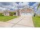 A well maintained single-story home featuring white brick accents, a two car garage, and a pristine lawn at 8811 Napa Loop, New Port Richey, FL 34653