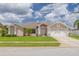 Charming single-story home with a well-manicured lawn, beautiful landscaping, and a two-car garage at 8811 Napa Loop, New Port Richey, FL 34653