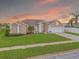 Charming single-story home with well-manicured lawn, white brick accents, and a colorful sunset backdrop at 8811 Napa Loop, New Port Richey, FL 34653
