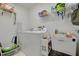 Functional laundry room equipped with a washer, dryer, sink, and ample storage space at 8811 Napa Loop, New Port Richey, FL 34653