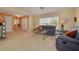 Cozy living room featuring neutral tile, comfortable furniture, and bright natural light at 8811 Napa Loop, New Port Richey, FL 34653