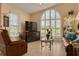 Inviting living room with vaulted ceiling, leather furniture, and an abundance of natural light at 8811 Napa Loop, New Port Richey, FL 34653