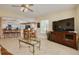 Open-concept living area with adjacent kitchen and stylish glass coffee table at 8811 Napa Loop, New Port Richey, FL 34653