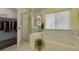 Bright bathroom with a separate shower and tub, and a walk-in closet at 8811 Napa Loop, New Port Richey, FL 34653