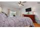 Comfortable primary bedroom featuring pool views and a ceiling fan at 8811 Napa Loop, New Port Richey, FL 34653
