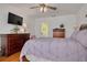 Cozy primary bedroom with wood floors and ensuite bathroom at 8811 Napa Loop, New Port Richey, FL 34653