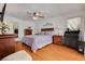 Spacious primary bedroom boasts wood floors, ceiling fan, and ample natural light at 8811 Napa Loop, New Port Richey, FL 34653