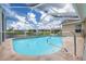 Refreshing pool with screened enclosure and a scenic lake view at 8811 Napa Loop, New Port Richey, FL 34653
