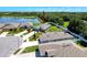 Aerial view of the property showing pond, lawn, and proximity to parking at 8855 Prairie Creek Dr, New Port Richey, FL 34655