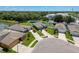 Aerial view of the home showing pond, lawn, and proximity to nearby amenities at 8855 Prairie Creek Dr, New Port Richey, FL 34655