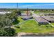Aerial view of the property backing onto a pond, featuring a screened lanai and a fenced yard at 8855 Prairie Creek Dr, New Port Richey, FL 34655