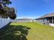 Fenced backyard with lawn maintenance equipment at 8855 Prairie Creek Dr, New Port Richey, FL 34655