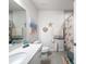 Bright bathroom with tile flooring, decorative wall hangings, and a modern vanity offering ample storage at 8855 Prairie Creek Dr, New Port Richey, FL 34655