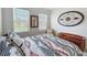 Serene bedroom with two bright windows and light neutral decor; cozy bench at the foot of the bed at 8855 Prairie Creek Dr, New Port Richey, FL 34655